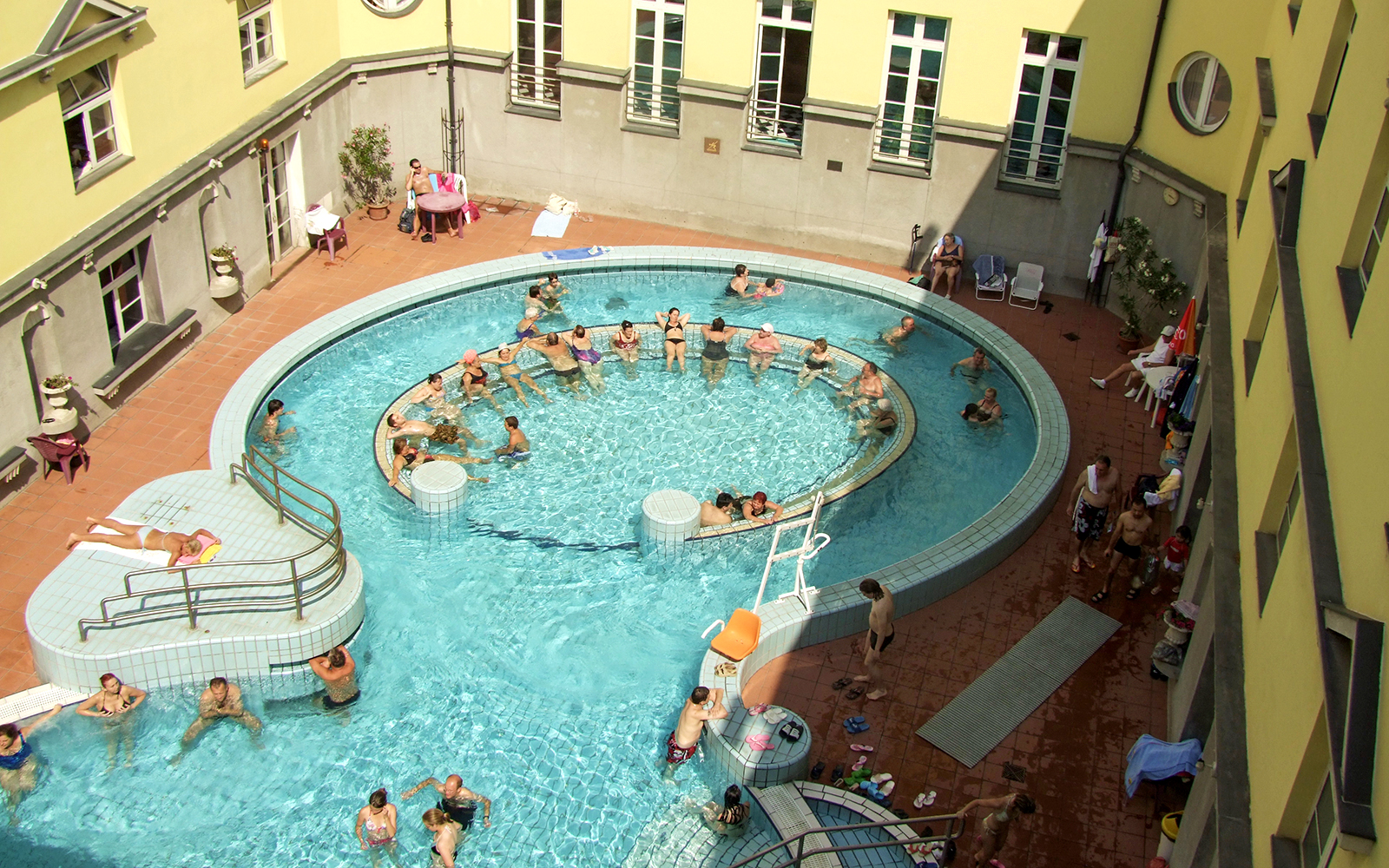 Aerial view of people enjoying the thermal pools at Lukacs Spa, Budapest.