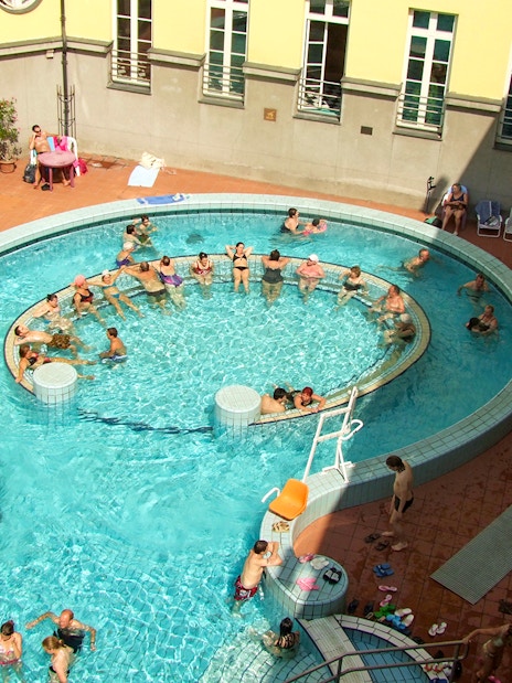 Aerial view of people enjoying the thermal pools at Lukacs Spa, Budapest.