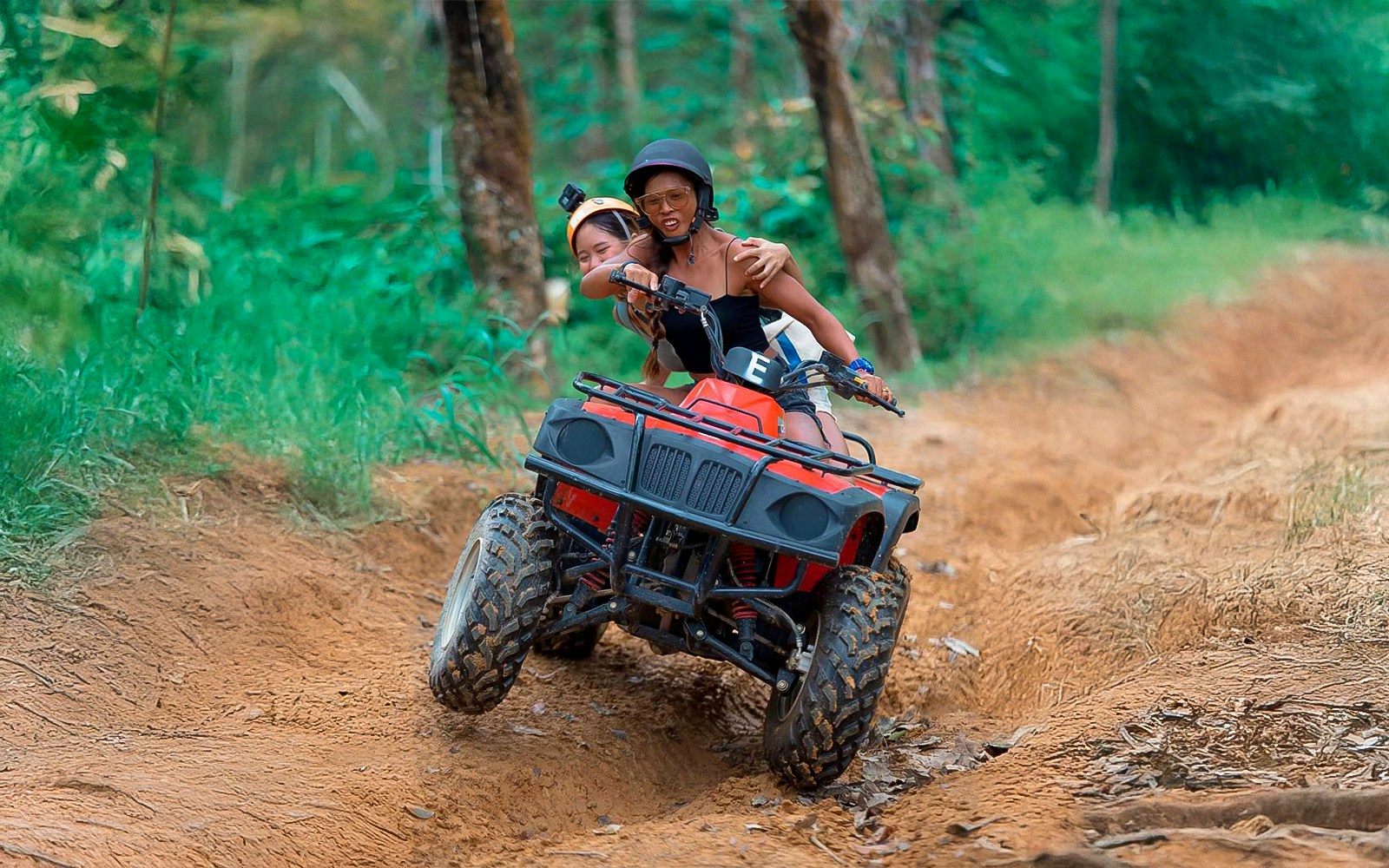 Group of tourists enjoying a 60-minute ATV adventure tour in the lush green landscapes near Phuket
