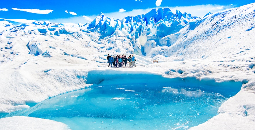 Tourists with guide hiking on Perito Moreno Glacier, Argentina.