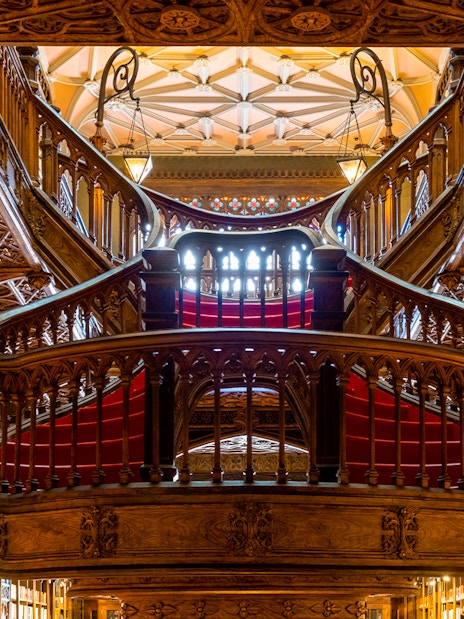 Lello Library's ornate wooden staircase and both floors in Porto, Portugal.