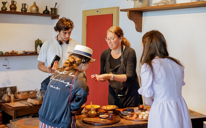 Guests engaging with a guide inside the Rembrandt House Museum, Amsterdam.