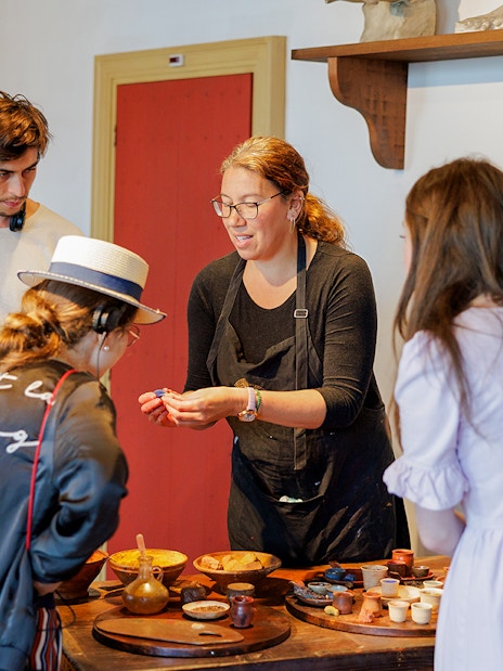 Guests engaging with a guide inside the Rembrandt House Museum, Amsterdam.