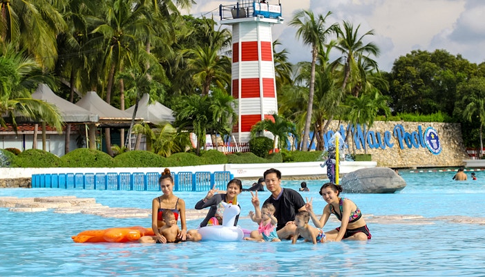 Wave pool at Siam Amazing Park with people enjoying the water and surrounding attractions in Bangkok, Thailand.