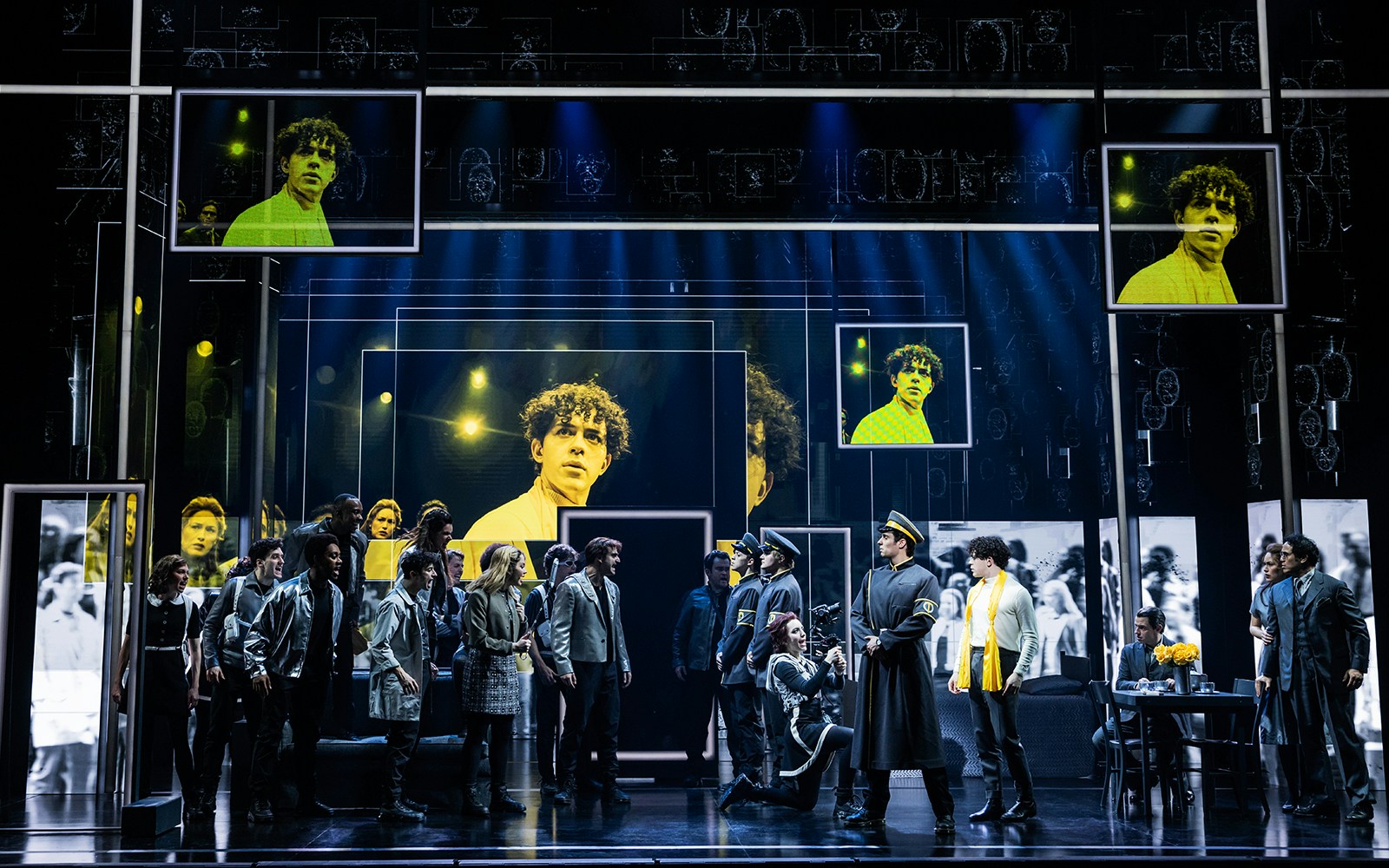 Stage performance of The Who’s Tommy with actors in dynamic poses and vibrant lighting.