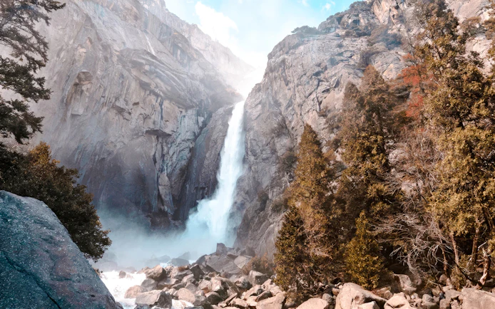 Waterfall cascading down rocky cliffs in Yosemite National Park.