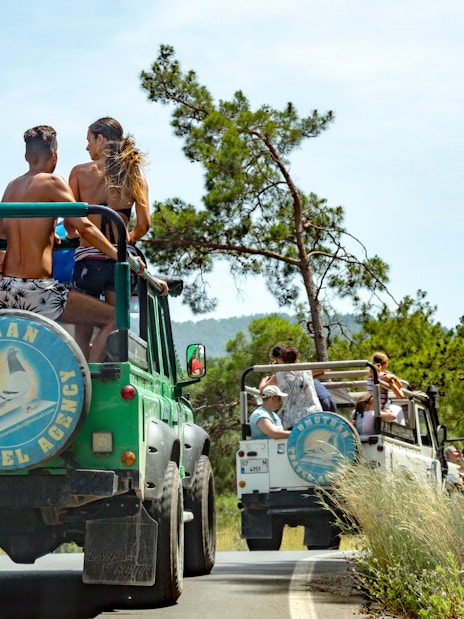 Tourists on a jeep safari in Antalya, driving through scenic mountain roads.