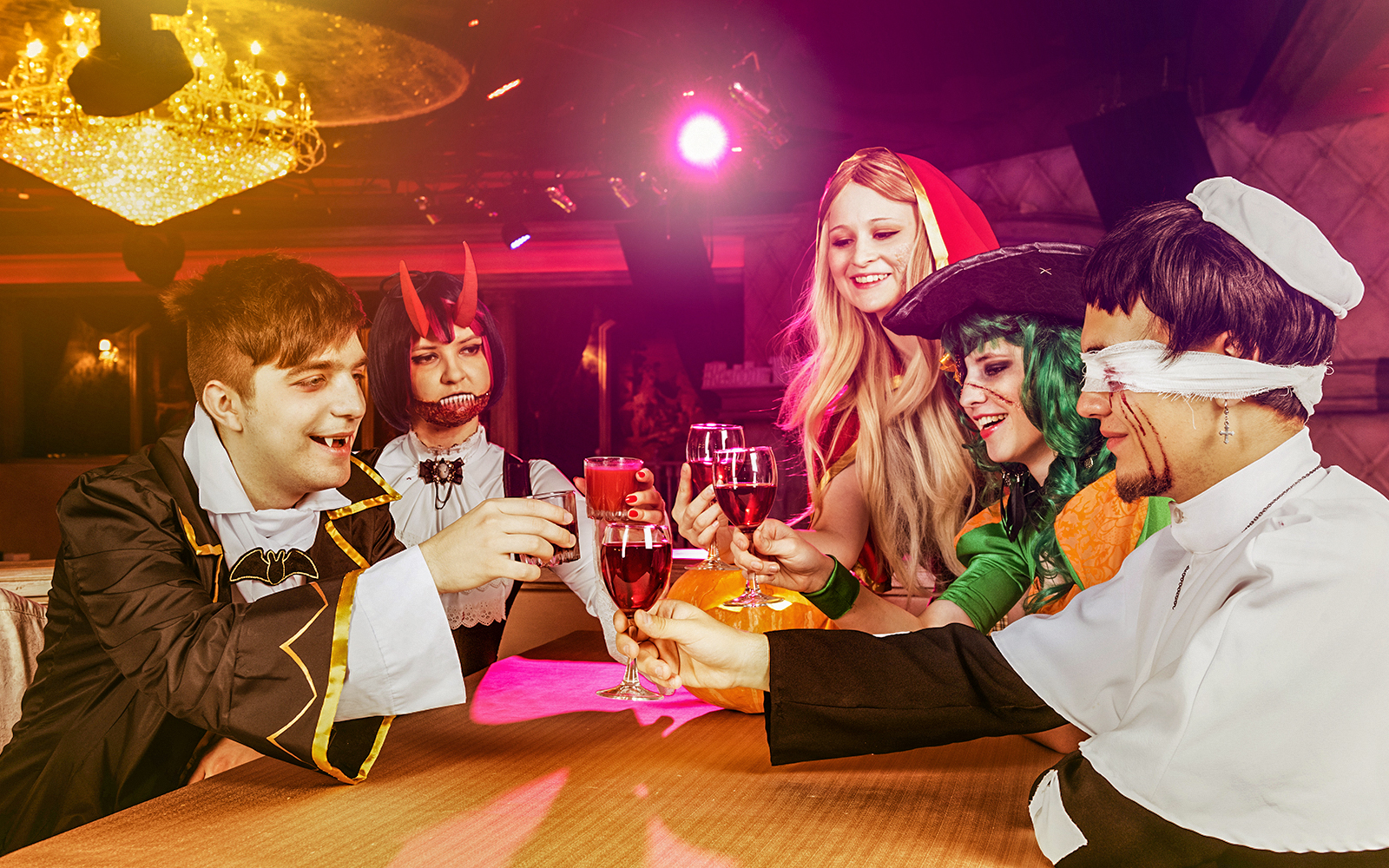 Guests in Halloween costumes toasting at Bran Dracula's Castle party.