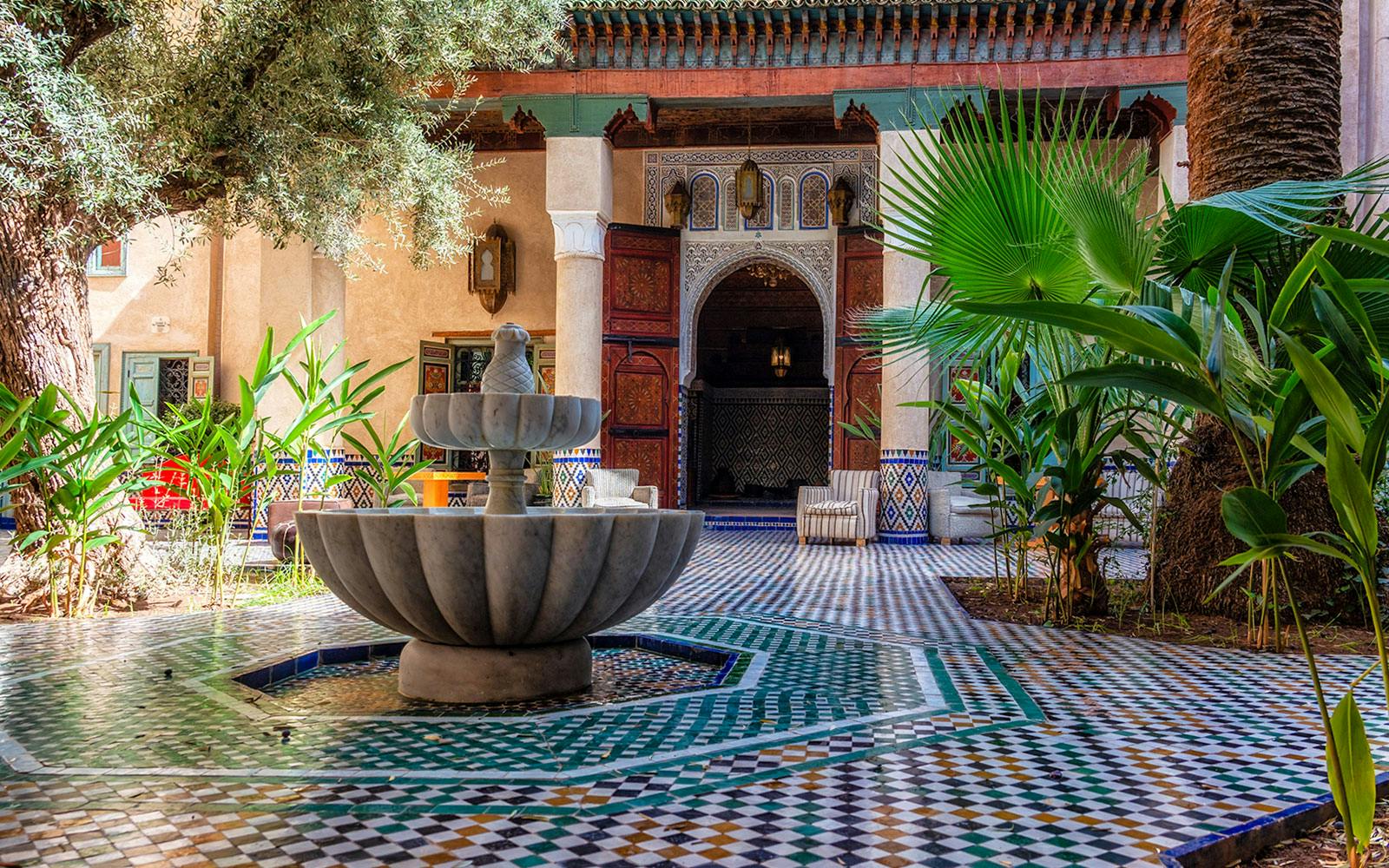 Moroccan Culinary Arts Museum courtyard with fountain and intricate tilework.