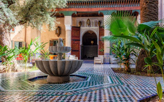 Moroccan Culinary Arts Museum courtyard with fountain and intricate tilework.