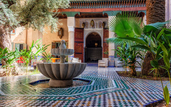 Moroccan Culinary Arts Museum courtyard with fountain and intricate tilework.