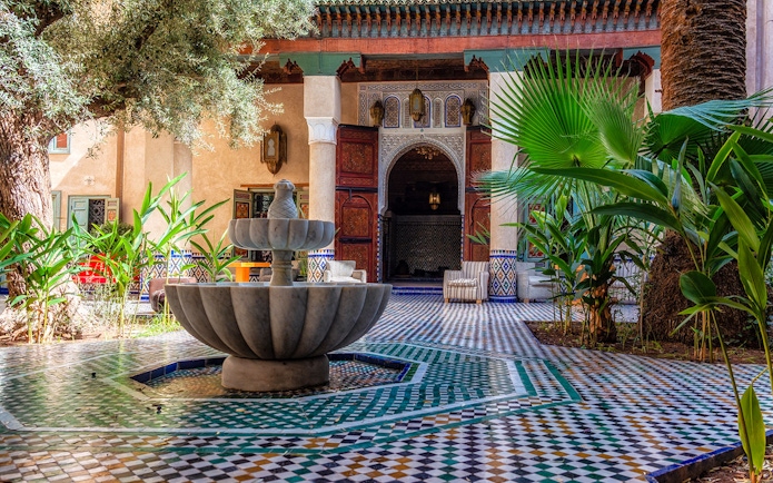 Moroccan Culinary Arts Museum courtyard with fountain and intricate tilework.
