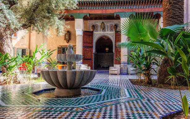 Moroccan Culinary Arts Museum courtyard with fountain and intricate tilework.