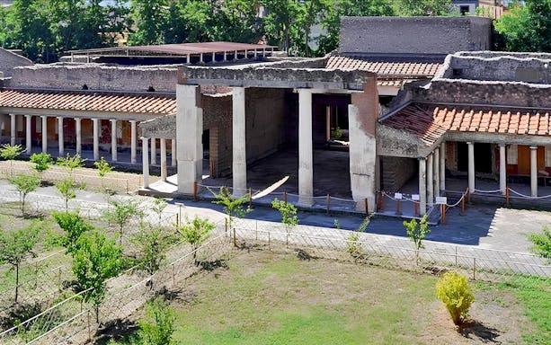 Ancient ruins of Oplontis villa with columns and courtyard, part of Pompeii and Oplontis small group tour.