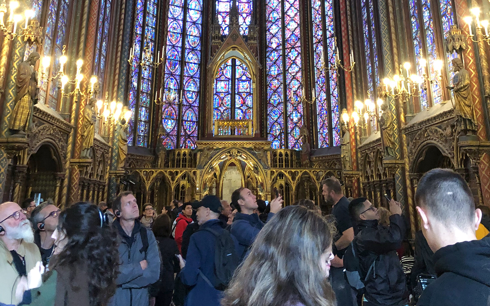 Visitors admire stained glass windows inside Sainte Chapelle, Paris.