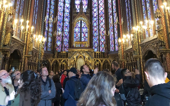 Visitors admire stained glass windows inside Sainte Chapelle, Paris.