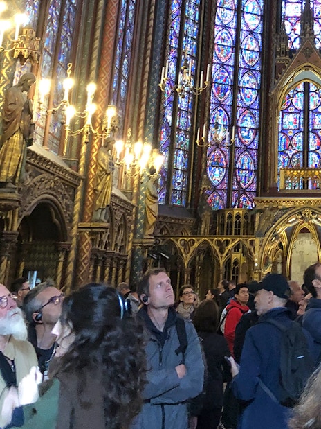 Visitors admire stained glass windows inside Sainte Chapelle, Paris.