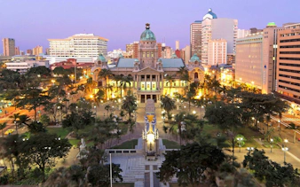 Durban City Hall illuminated at dusk during Half Day Durban City Sightseeing Tour.
