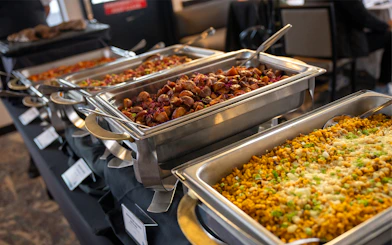 Buffet dishes on San Diego Signature Dinner Cruise with roasted potatoes and corn casserole.