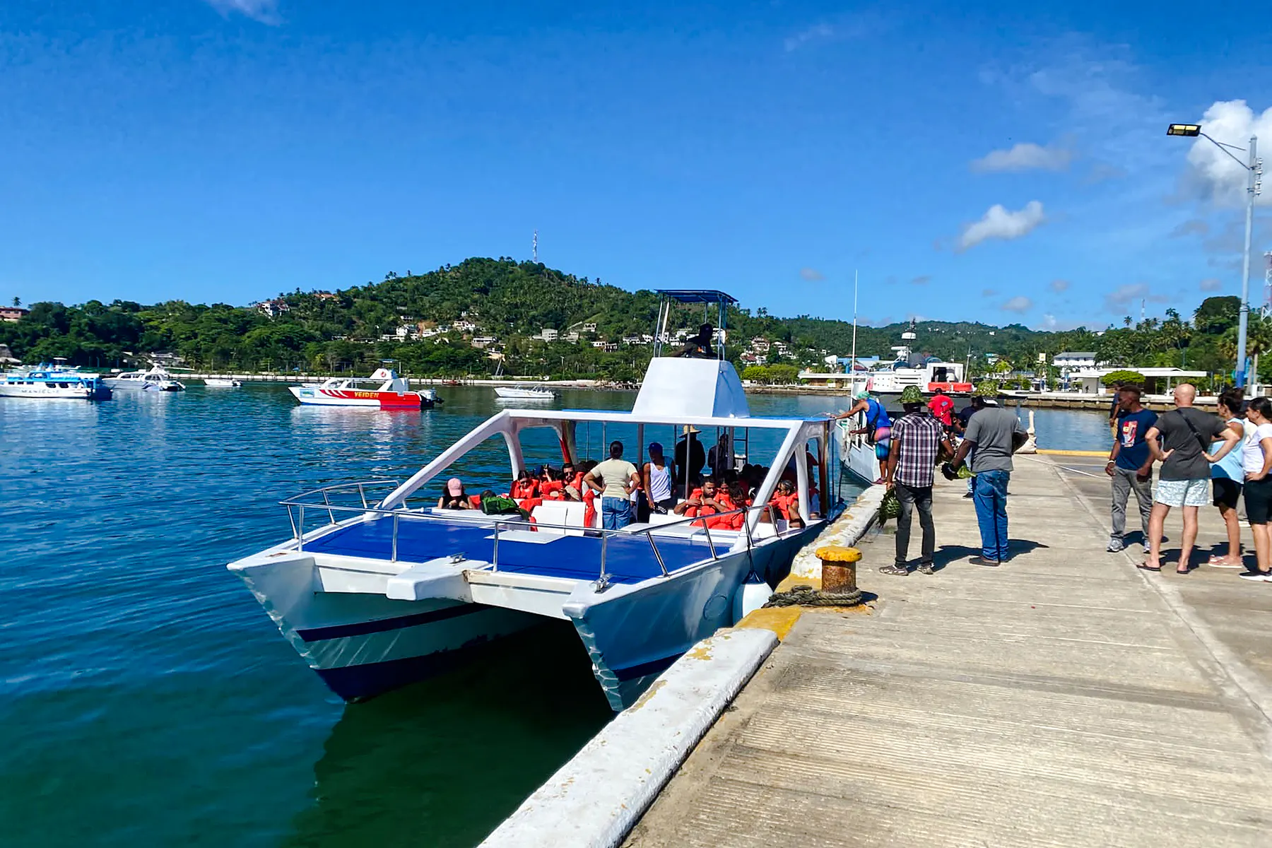 Catamaran docked with tourists boarding for Samana day trip from Santo Domingo, Dominican Republic.