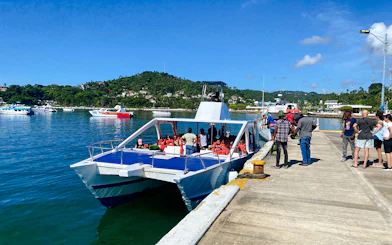 Catamaran docked with tourists boarding for Samana day trip from Santo Domingo, Dominican Republic.