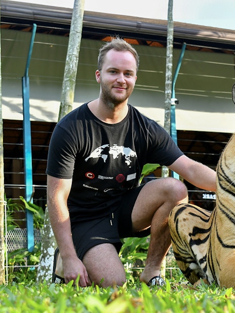 Non-Thai tourist with tiger at Tiger Park Pattaya.