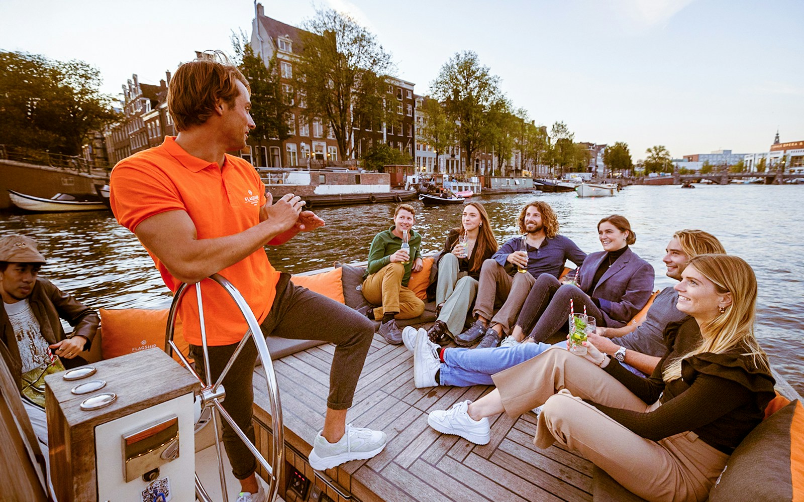 Evening canal cruise boat on Amsterdam's illuminated waterways.