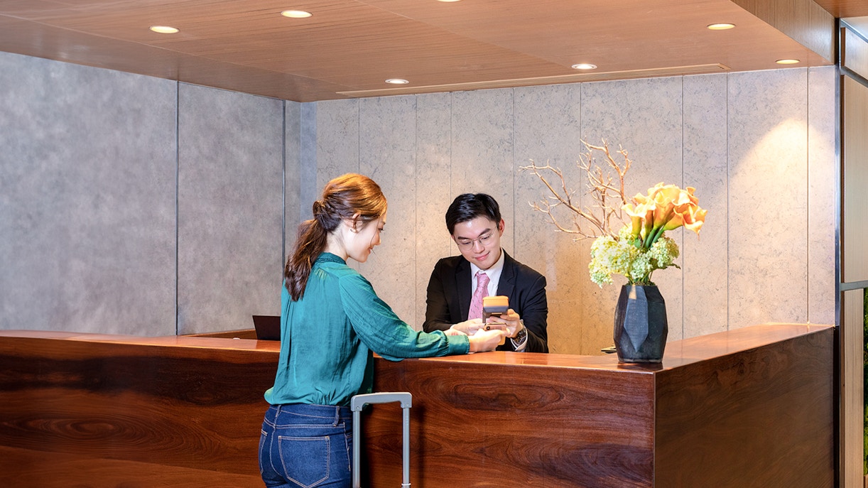 Guest checking in at Plaza Premium Lounge, Hong Kong International Airport.