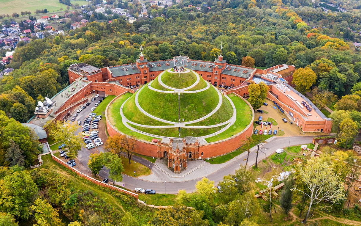 Aerial view of Kościuszko Mound surrounded by trees in Krakow, Poland.