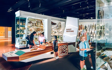 Visitors exploring the Many Nations exhibit at Melbourne Museum.