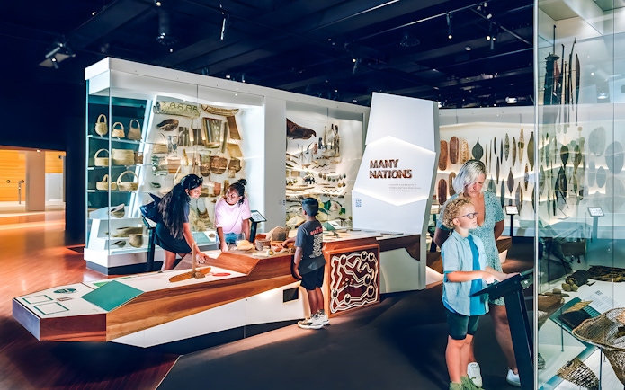 Visitors exploring the Many Nations exhibit at Melbourne Museum.