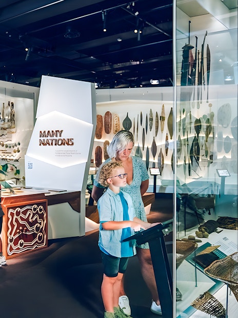 Visitors exploring the Many Nations exhibit at Melbourne Museum.