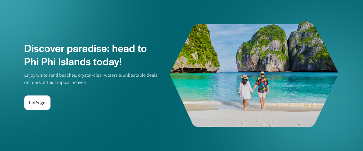 Couple walking on white sand beach with limestone cliffs in Phi Phi Islands, Phuket, Thailand.