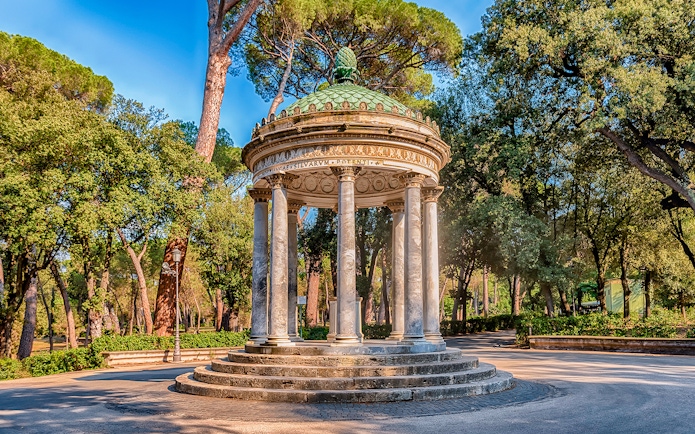 Borghese Gardens temple surrounded by trees, Rome, Italy.