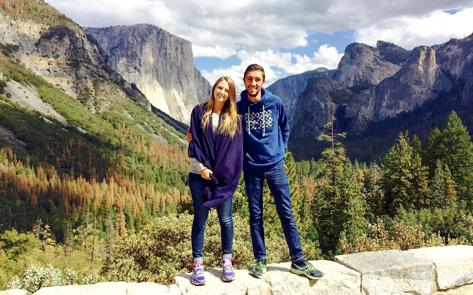 Couple standing at Yosemite National Park with El Capitan in the background, California.