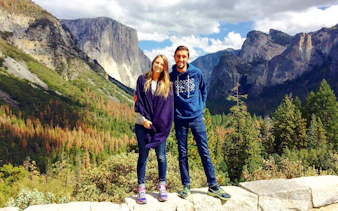 Couple standing at Yosemite National Park with El Capitan in the background, California.
