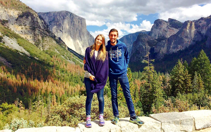Couple standing at Yosemite National Park with El Capitan in the background, California.