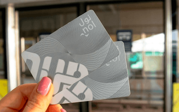 Dubai Metro Silver NOL Card held in front of station entrance.
