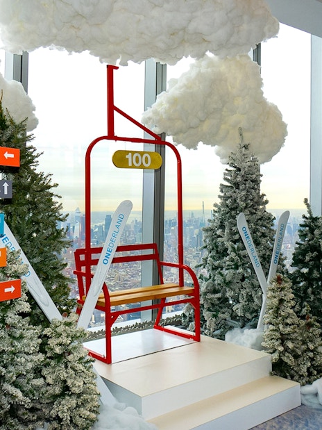 One World Observatory winter-themed display with directional signs and city view.