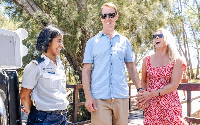 Couple enjoying Swan Valley Wine Cruise with guide in sunny outdoor setting.