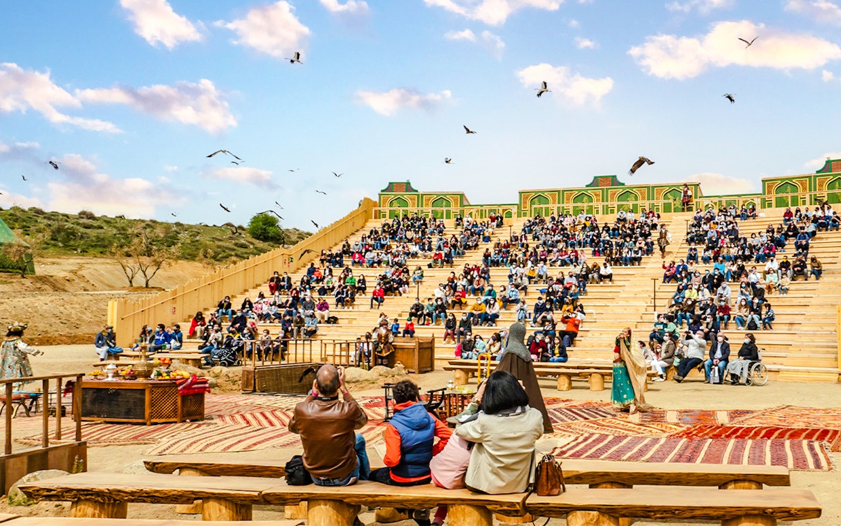 Audience watching an outdoor performance at Puy du Fou park show.