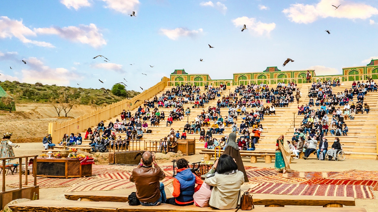 Puy du Fou park show with performers in historical costumes reenacting a medieval battle scene.