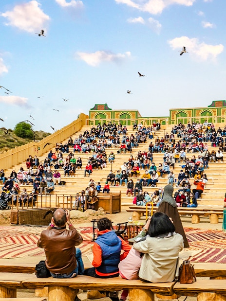 Audience watching an outdoor performance at Puy du Fou park show.