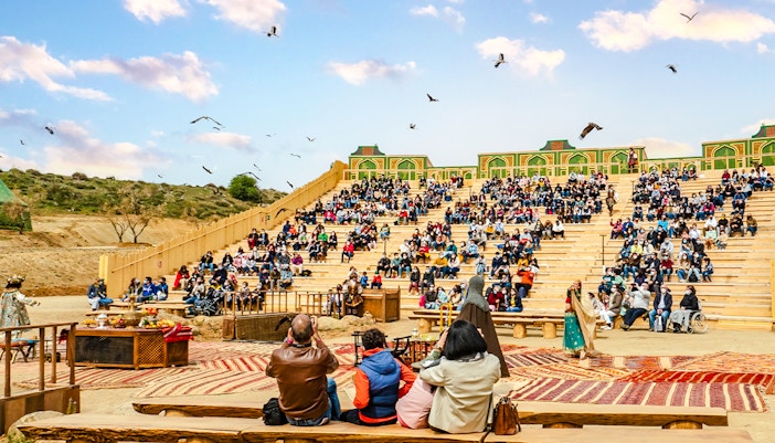 Puy du Fou park show with performers in historical costumes reenacting a medieval battle scene.