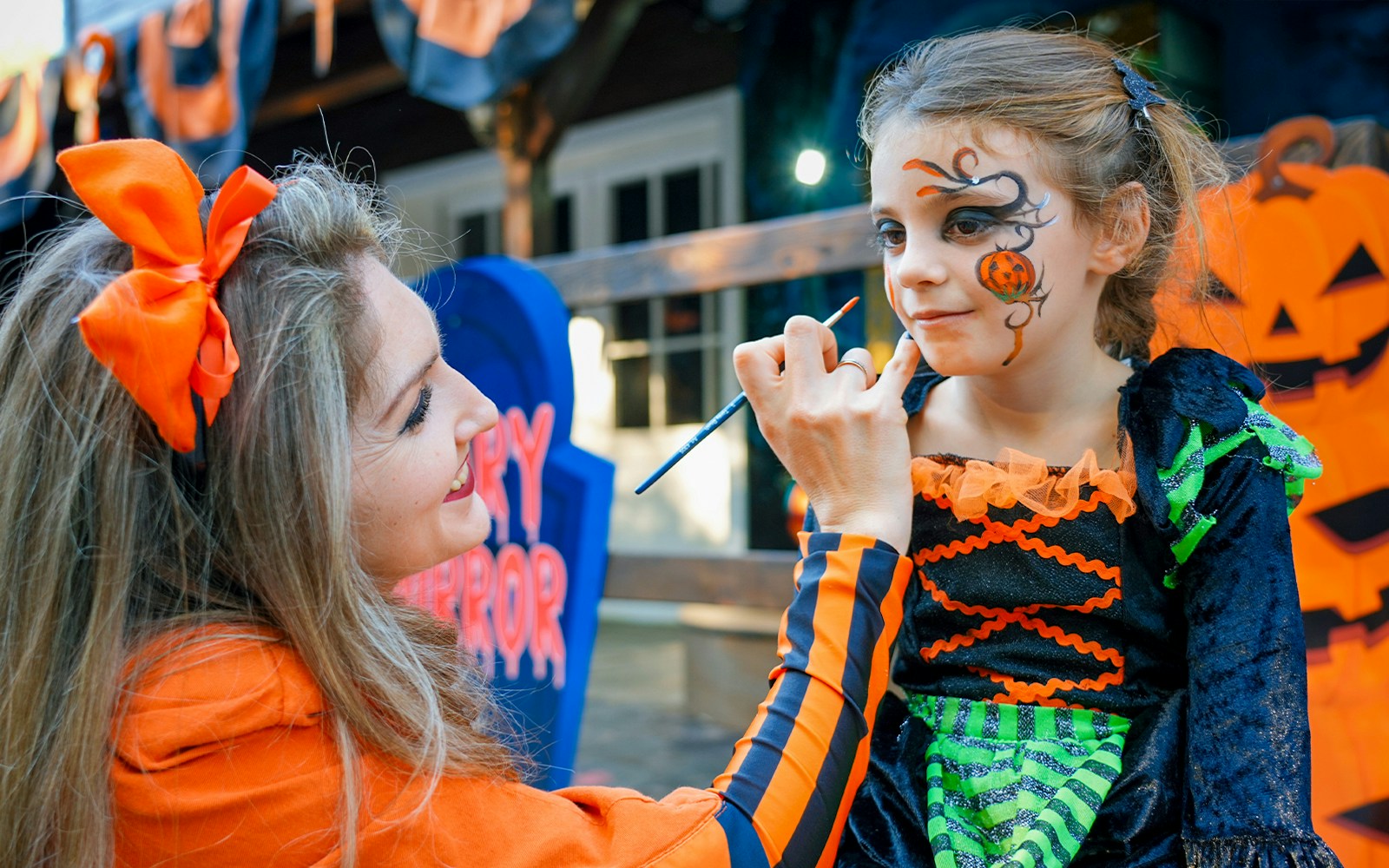 Child having face painted at Gardaland Halloween event in Italy