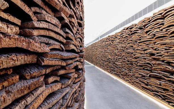 Cork walls at Planet Cork exhibit, showcasing stacked cork slabs.