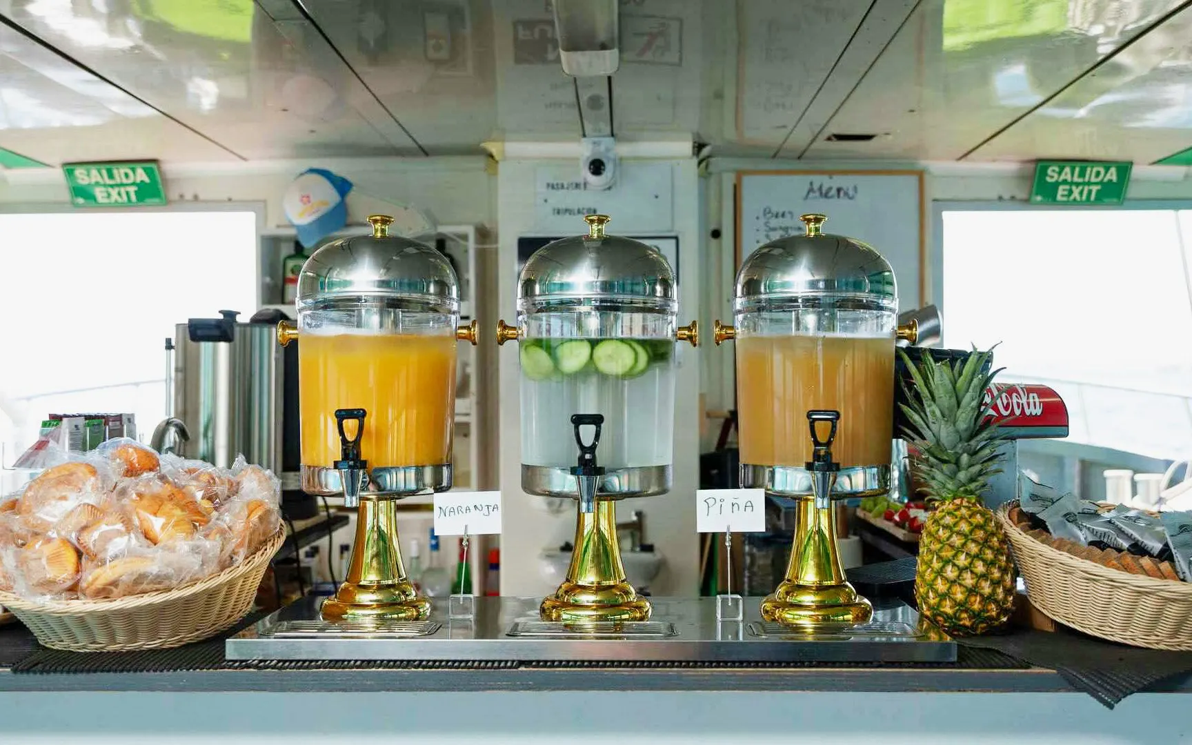 Juice dispensers and breakfast pastries on Ibiza to Formentera cruise.