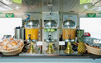 Juice dispensers and breakfast pastries on Ibiza to Formentera cruise.