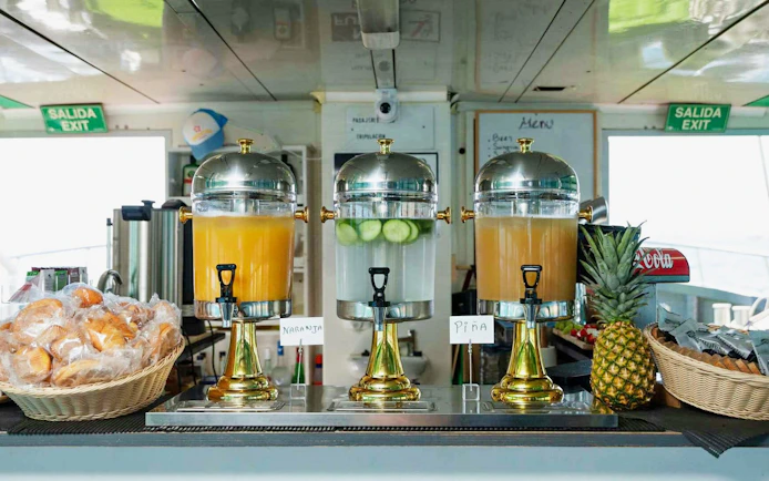 Juice dispensers and breakfast pastries on Ibiza to Formentera cruise.