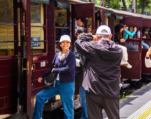 Passengers boarding Puffing Billy steam train vintage carriage near Melbourne station.